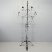 A painted wrought metal gothic candelabra converted to electric. Height 185cm.