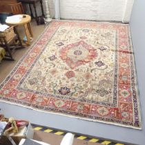A red and cream ground Tabriz carpet. 337x247cm. Good condition. Some visible lines where it has