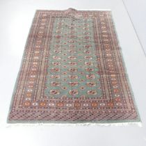 *WITHDRAWN * An antique blue-ground Afghan silk rug. 190x127cm.