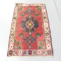 A red ground Afghan rug. 130x80cm