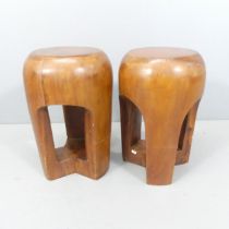 A pair of brutalist solid wood carved stools. 31x46cm.