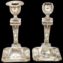 A pair of George V Neo-Classical style table candlesticks, Atkin Brothers, Sheffield 1924, relief