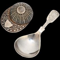 An Elizabeth II novelty silver jockey cap tea caddy spoon, Francis Howard, Sheffield 1981, and a