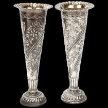 A pair of late Victorian silver trumpet bud vases, William Comyns, London 1900, relief embossed