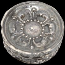 A 17th century miniature silver gaming counter box, circular form with relief embossed rosette