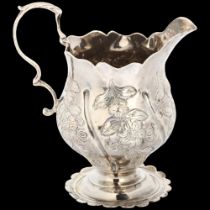 A George III silver helmet cream jug, David Mowden, London 1763, relief embossed floral