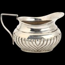A Victorian silver cream jug, John Wilmot, Birmingham 1897, relief embossed half fluted