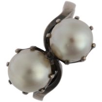 An 18ct white gold two stone whole pearl crossover ring, claw set with 7.7mm pearls, size L, 5.7g No