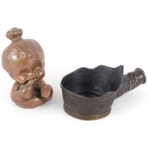 A Chinese silk iron, and a hollowed brass mid-century mould, used for casting rubber dolls, H14.