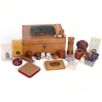 A Victorian walnut sewing box and contents, including treen sewing boxes, pin cushions, thimbles,