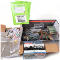 A box of various model railway accessories