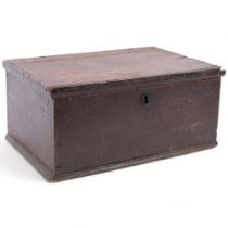 An 18th century oak candle box, with a quantity of candles, 34cm across