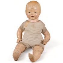 A Horsman composition doll, with soft body and composition limbs, circa 1920s, and 24 outfits