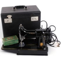A Vintage Singer Featherweight 221K sewing machine, with associated case and accessories, case