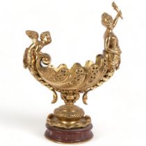 A large Antique gilt-bronze table centre, the shell bowl surmounted by a cherub to the rear and a