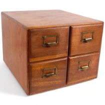 An early 20th century oak index filing cabinet, fitted with 4 short drawers with brass handles, 37cm