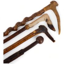 2 staghorn handled walking sticks, another with deer's foot handle, and a walking stick with