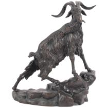 Patinated bronze figure of a mountain goat on rocks, signed, 22.5cm
