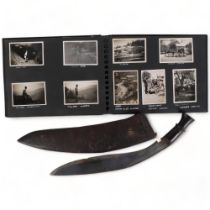 A Malayan kukri knife in leather scabbard, and a photograph album containing photographs from