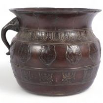 An Indian embossed and engraved patinated brass vessel, with engraved and applied decoration, single