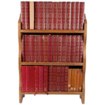 A pine bookcase containing a collection of Dennis Wheatley books, distributed by Heron books,