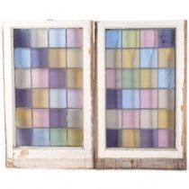 A pair of early 20th century coloured leadlight window panes, in painted frames, panels 62.5cm x
