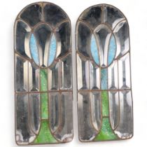 A pair of arch-top coloured and mirrored glass panels, with brass beading, H70cm, W28cm