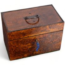 A 19th century amboyna tea caddy, lid having swing handle and applied decoration, fitted with a