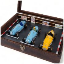 A table-top display case, containing 3 “Merit” plastic 1:24 scale model Talbot-Lago Grand Prix