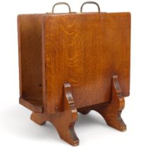 An Art Deco oak and marquetry decorated magazine rack with brass handles, monogramed WHS, H45cm