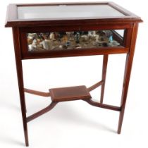 An Edwardian inlaid mahogany vitrine cabinet, containing miniature cups and saucers, animals,