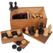 A box of turned wood chessmen, and a box of draughts pieces