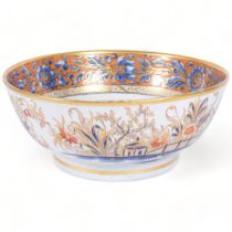 A large 19th century ironstone centre bowl, with painted and gilded decoration depicting pagoda