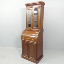 A Victorian mahogany two-section cylinder front bureau bookcase, with two glazed doors, a slide