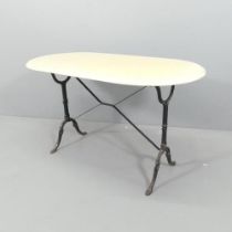 A oval marble topped garden table on cast iron base. 120x71x60cm. Some very minor nibbles to the