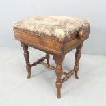 A Victorian mahogany aesthetic movement piano stool with upholstered seat. 49x50x37cm. Rise and fall