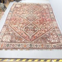 A red and cream-ground Heriz carpet. 286x220cm. Areas of low pile and fringe loss. Some loss to