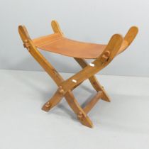 A modern folding Scissor chair with leather seat. 69x62x40cm.