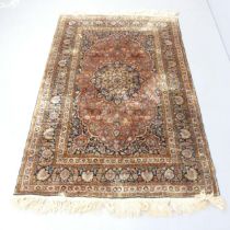 A brown-ground Heriz rug. 187x15cm. Very faded in places.