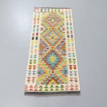 A Chobi Kilim runner. 143x61cm.