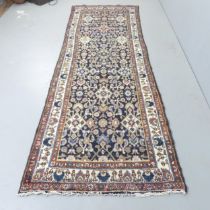 A red and cream-ground Persian runner. 300x103cm.