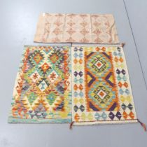 A Chobi Kilim mat, 95x62cm, another, 92x60cm, and an embroidered wool shawl. (3)