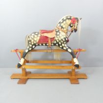 A painted rocking horse on stand, with carved detail and horse-hair maine and tail. Vendor informs