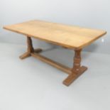 ROBERT MOUSEMAN THOMPSON - An oak refectory style dining table, with 4cm thick plank top, raised