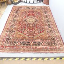 A red and cream-ground Lilihan carpet. 305x209cm.