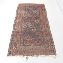 A red and blue-ground Turkoman rug. 183x94cm. Some areas of loss and low pile. Missing fringe and