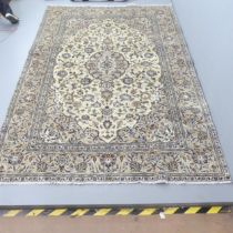 A cream-ground Kirman carpet. 284x188cm.