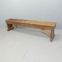 A vintage stained pine folding bench. 187x46x29cm.