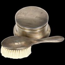 An engine turned silver-backed hand brush, Birks, an early 20th century sterling silver circular