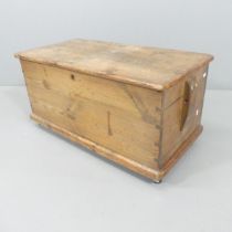 A vintage stained pine toolbox, raised on casters. 83x41x42cm.